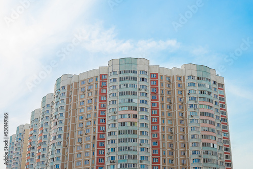 Residential multi-storey building against the blue sky. Real estate, apartment building, Industrial city theme	