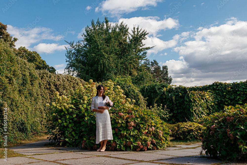 beautiful girl in a white dress in the park