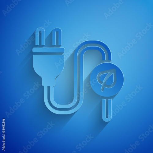 Paper cut Electric saving plug in leaf icon isolated on blue background. Save energy electricity. Environmental protection. Bio energy. Paper art style. Vector