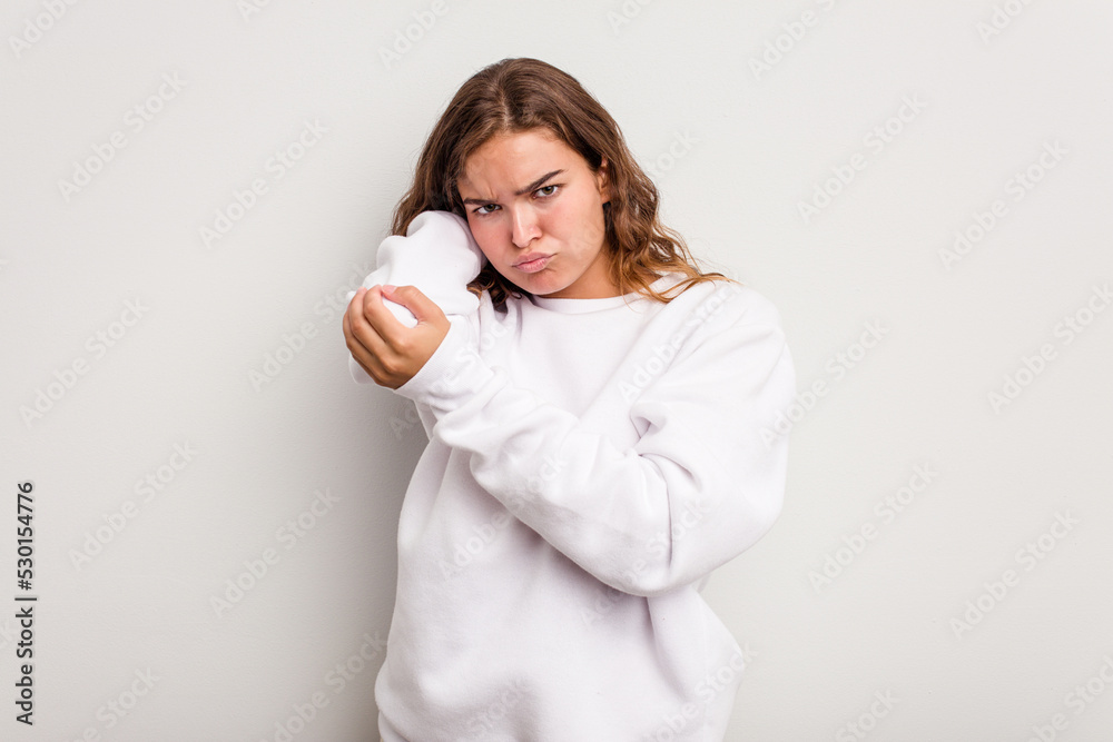 Young caucasian woman isolated on blue background having a neck pain due to stress, massaging and touching it with hand. Young caucasian woman isolated on blue background having a neck pain due to stress, massaging and touching it with hand.