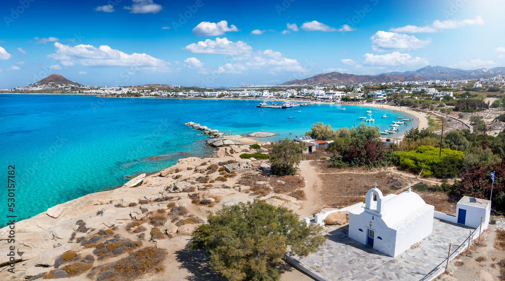 Panoramic view to the bay, beach and church of Agia Anna, Naxos island, Cyclades, Greece, with turquoise sea during summer time