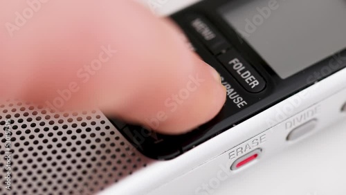 Dictaphone close-up. Pressing the record on the voice recorder.