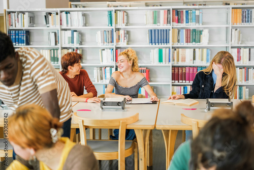 Group of students studying in the university library preparing final exams
