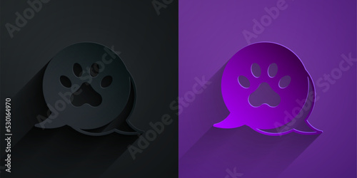 Paper cut Paw print icon isolated on black on purple background. Dog or cat paw print. Animal track. Paper art style. Vector