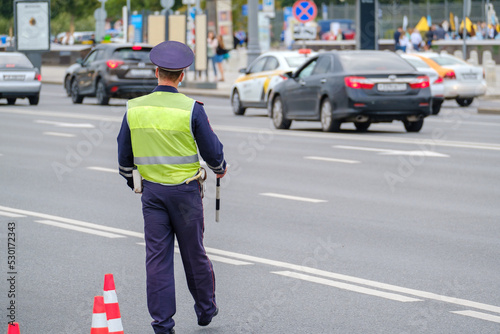 Traffic officer standing near road © Anton Gvozdikov