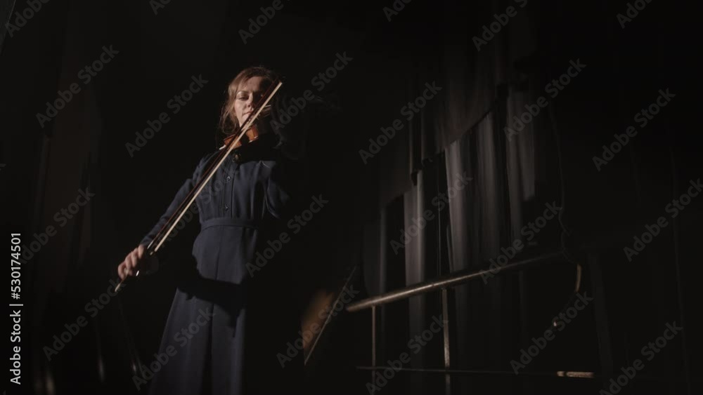 Female violinist performing on stage