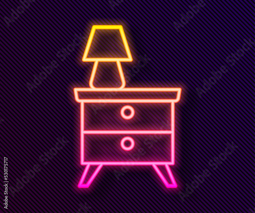 Glowing neon line Furniture nightstand with lamp icon isolated on black background. Vector
