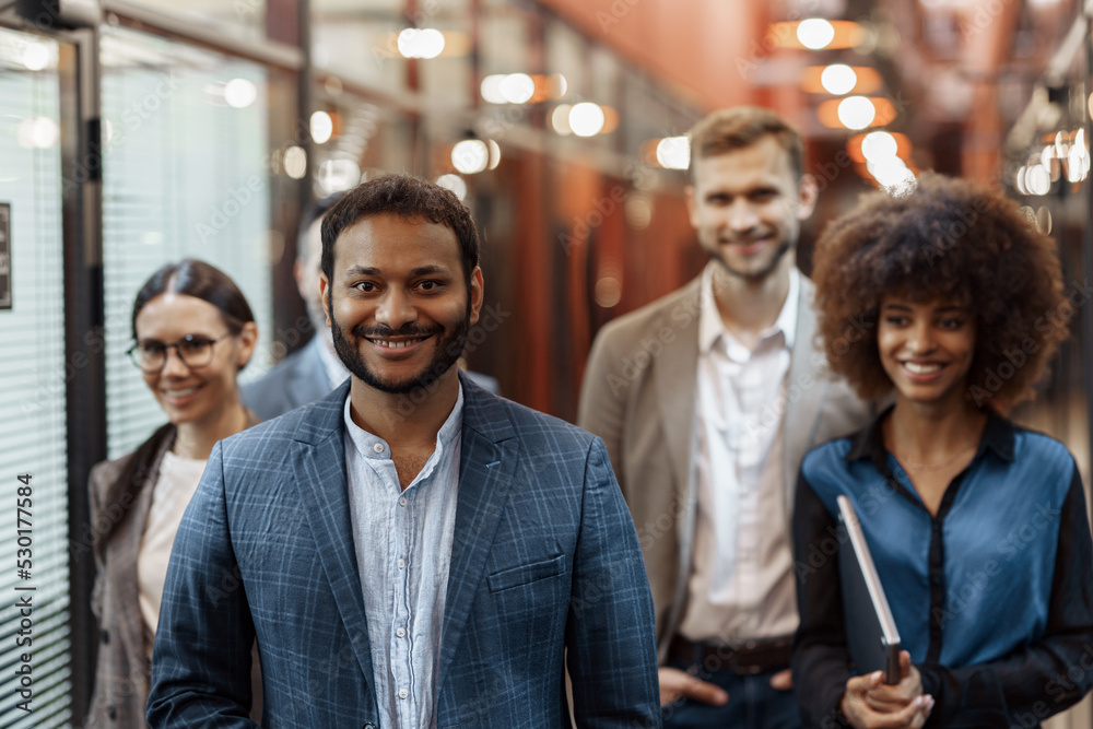 Multiethnic group of business people standing in office during break. Teamwork concept Multiethnic group of business people standing in office during break. Teamwork concept