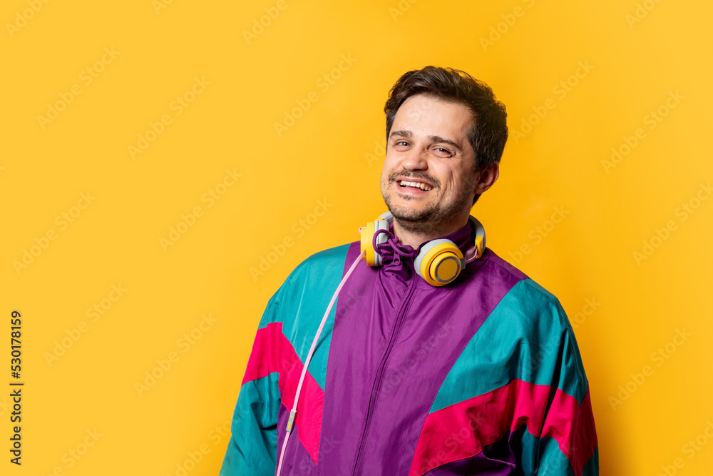 Stylish guy in 80s sport suit with headphones Stylish guy in 80s sport suit with headphones