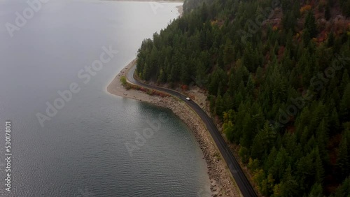 Wallpaper Mural Aerial footage of car driving on lakeside road in the mountains Torontodigital.ca