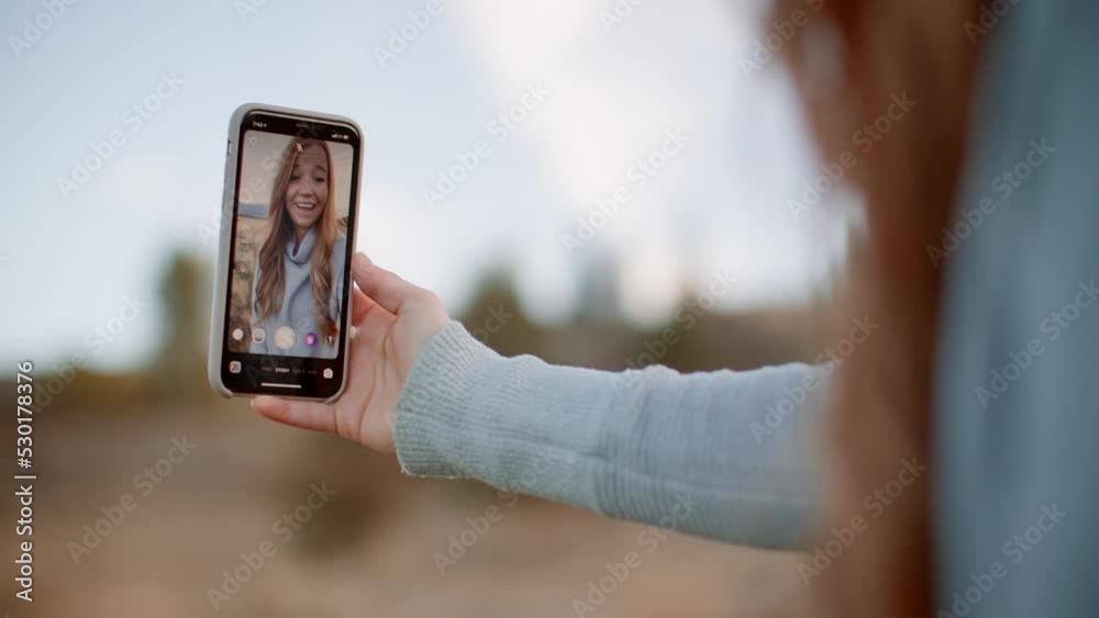 Girl content creator taking selfie video for social media on phone