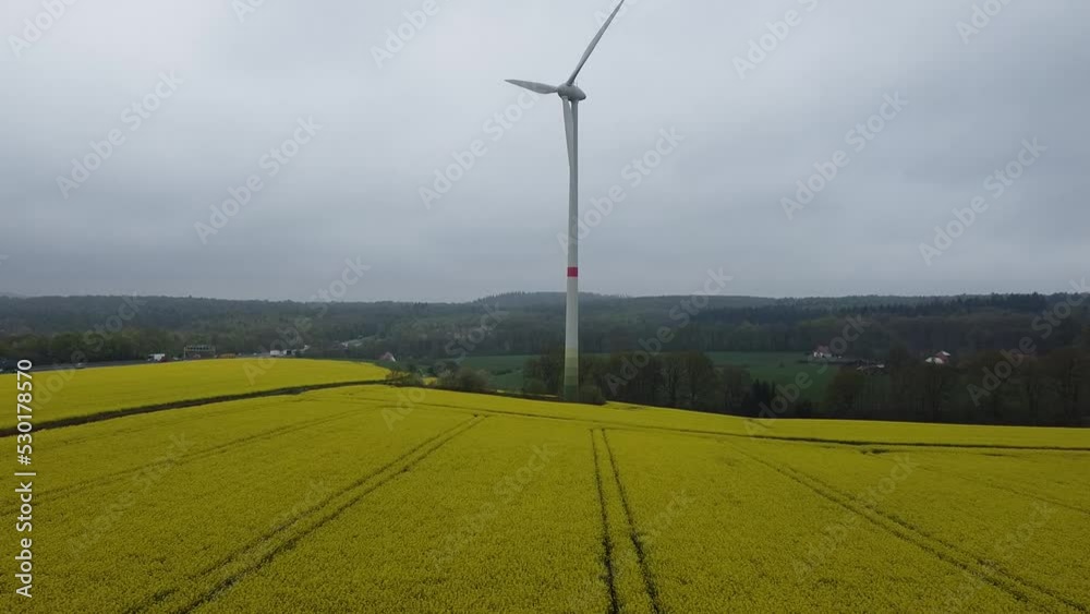 Wind turbine over rapes field aerial view Wind turbine over rapes field aerial view