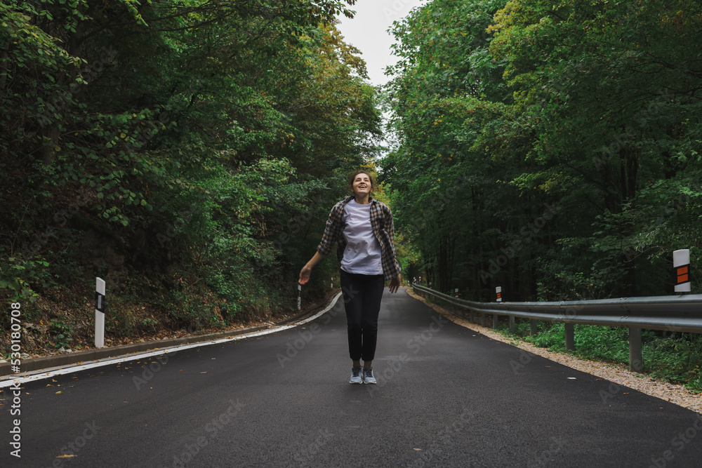 beautiful girl walks in the forest near the road beautiful girl walks in the forest near the road