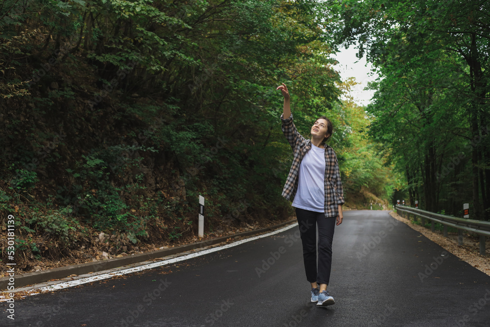 beautiful girl walks in the forest near the road beautiful girl walks in the forest near the road
