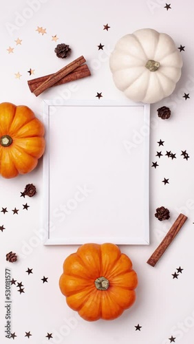 Stop motion animation mock up flat lay of mini decorative orange pumpkin, cinnamon sticks, little pine cone, stars on bright. Halloween and Thanksgiving greeting card holiday concept with copy space.