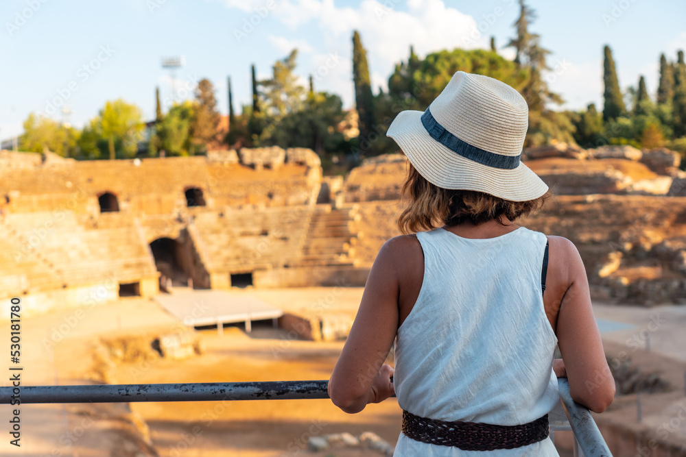 Roman Ruins of Merida, a young woman visiting the Roman Amphitheater. Extremadura, Spain