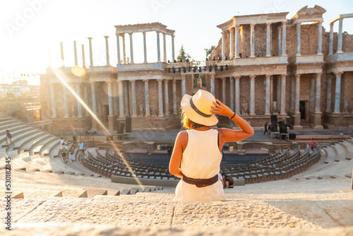 Roman Ruins of Merida, a young tourist in a white dress visiting the Roman Theater. Extremadura, Spain photo