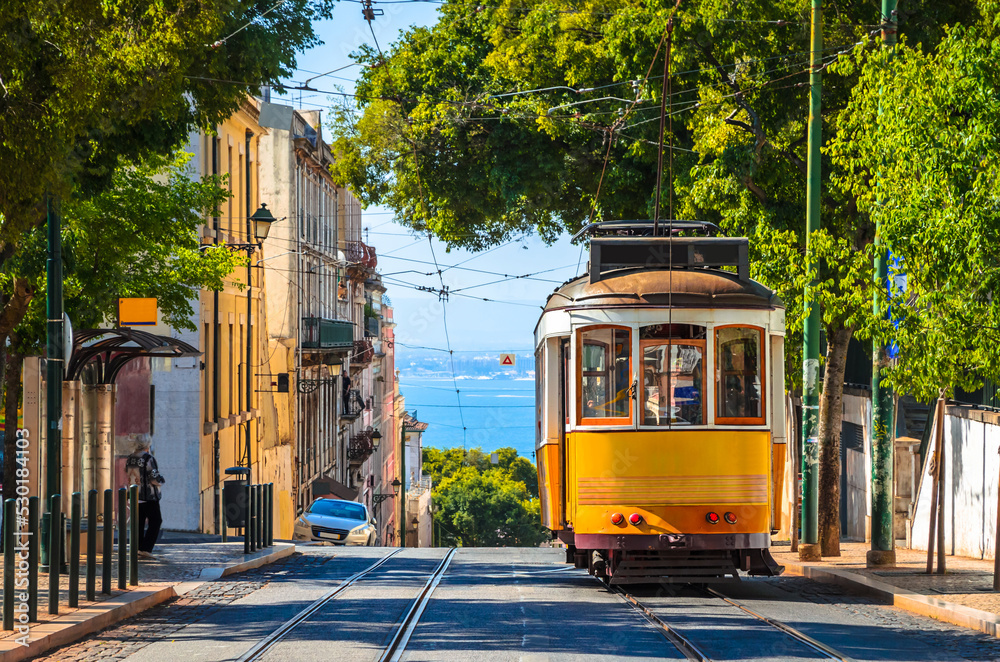 Obraz na płótnie Famous yellow vintage tram in the street of Alfama, Lisbon, Portugal w salonie