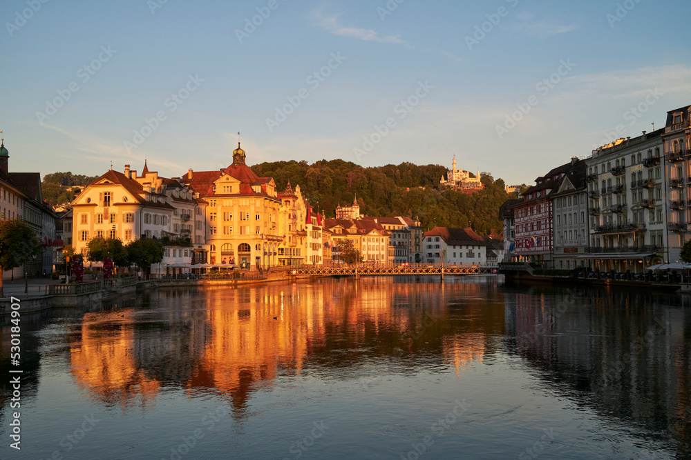 Historic architecture of old city located on river shore at sunset
