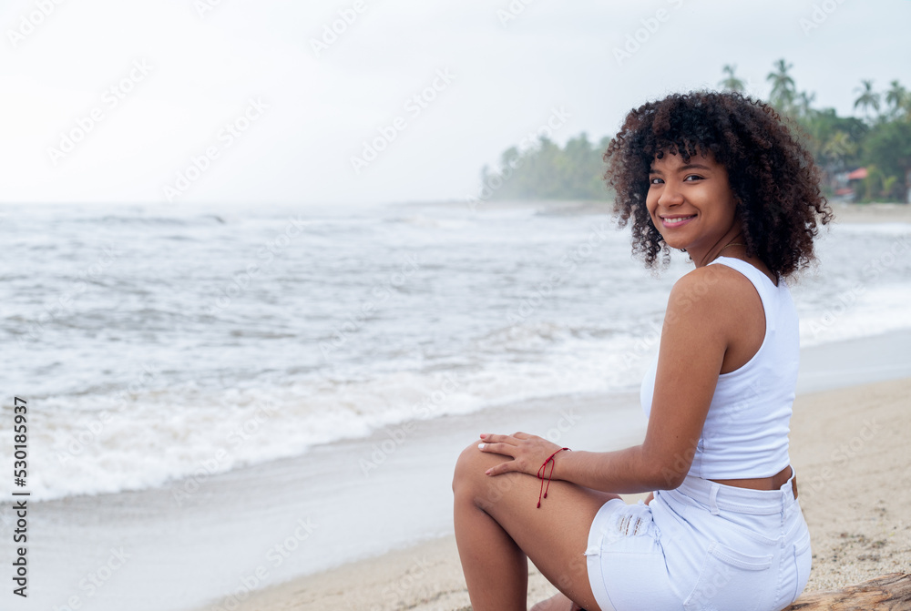 Happy smiling young woman in the beach during summer vacation Happy smiling young woman in the beach during summer vacation