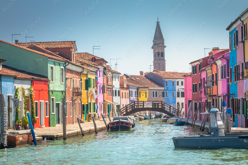 Burano island canal, colorful houses and boats, Venetian lagoon, Italy
