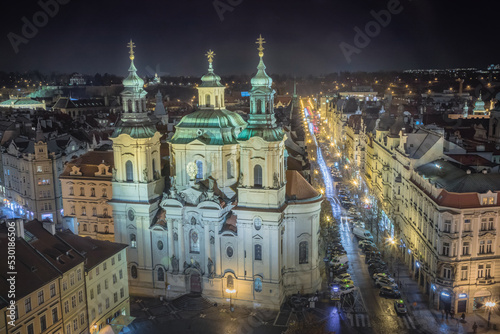 Above baroque church of Saint Nicholas in Prague old town square at night