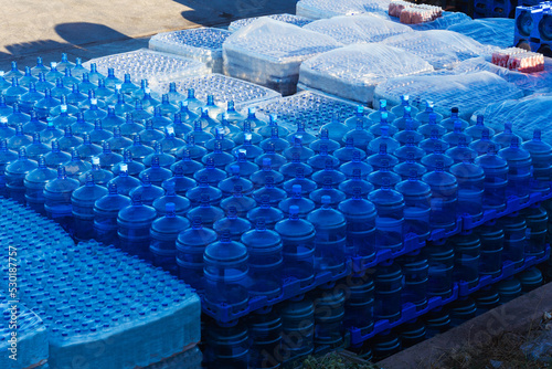 delivery of drinking water to the island in istanbul. replenishment of provisions and water by sea. storage of clean bottled water on the pier. waiting for food and water to be loaded onto the ship photo