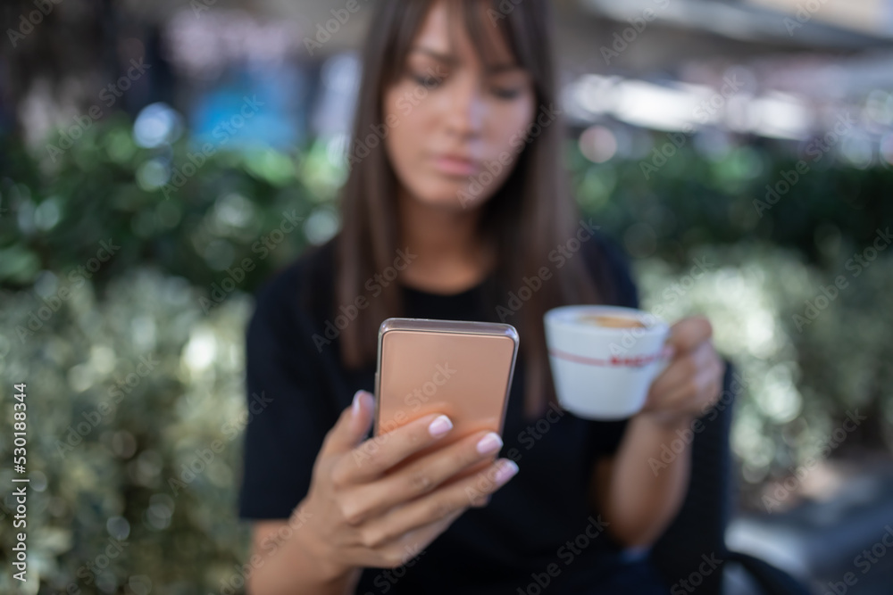 Morning in cafe - attractive woman in black drinkin coffe and make selfie photo for social networks Morning in cafe - attractive woman in black drinkin coffe and make selfie photo for social networks