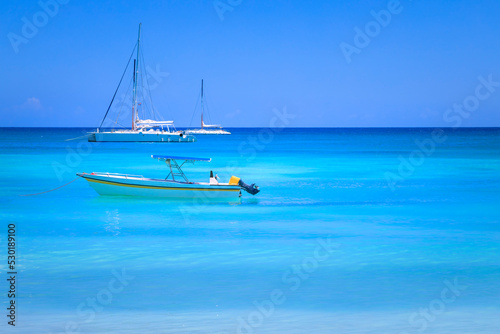 Fototapeta Naklejka Na Ścianę i Meble -  Tropical idyllic caribbean beach with sailboats, Punta Cana, Dominican Republic