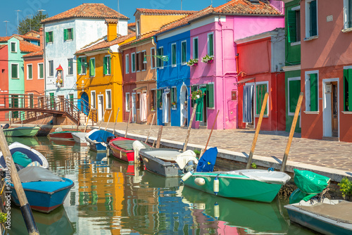 Burano island canal, colorful houses and boats, Venetian lagoon, Italy © Aide
