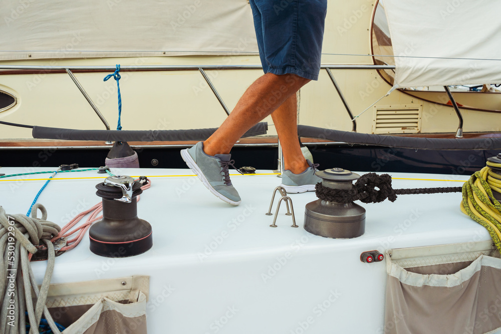 beginner courses for men on a sailing yacht. a man pulls a rope from a ...