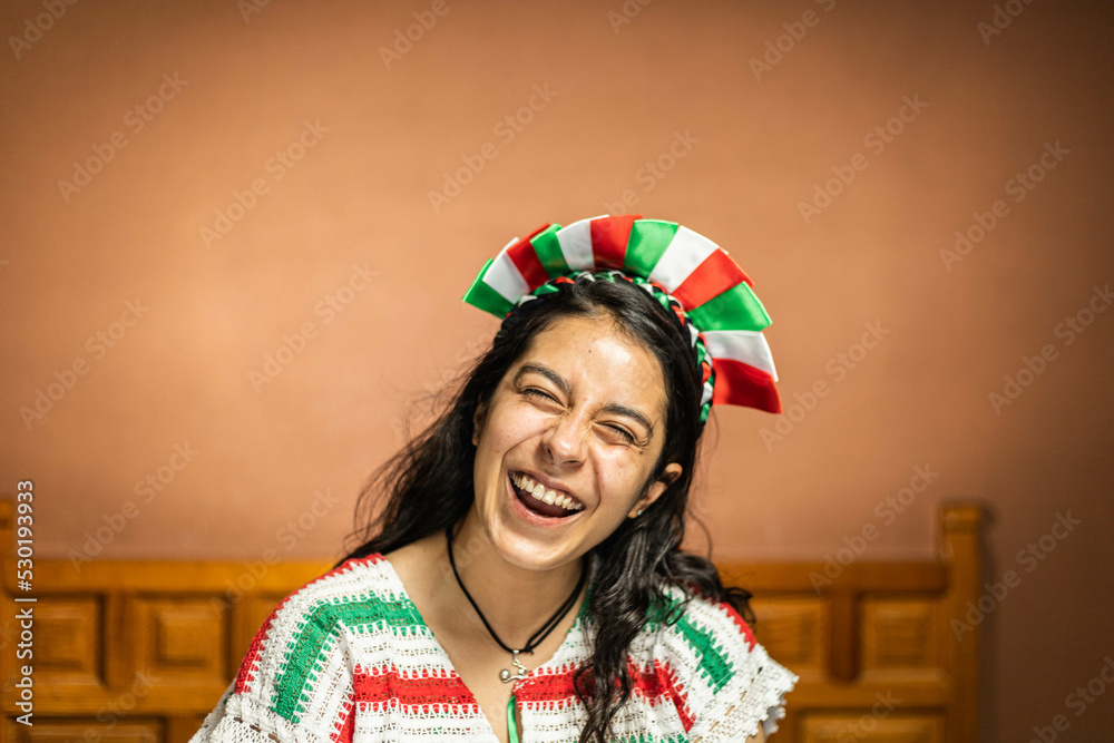 Mexican woman dressed in clothes of the patriotic colors on her head, smiling Mexican woman dressed in clothes of the patriotic colors on her head, smiling