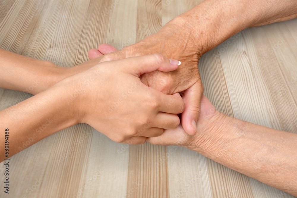 Fototapeta premium Human sitting at table, holding hands. Arms on the desk