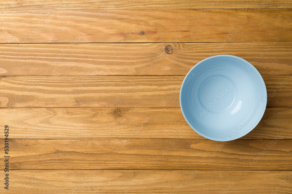 Empty round plate on wooden background, top view Empty round plate on wooden background, top view