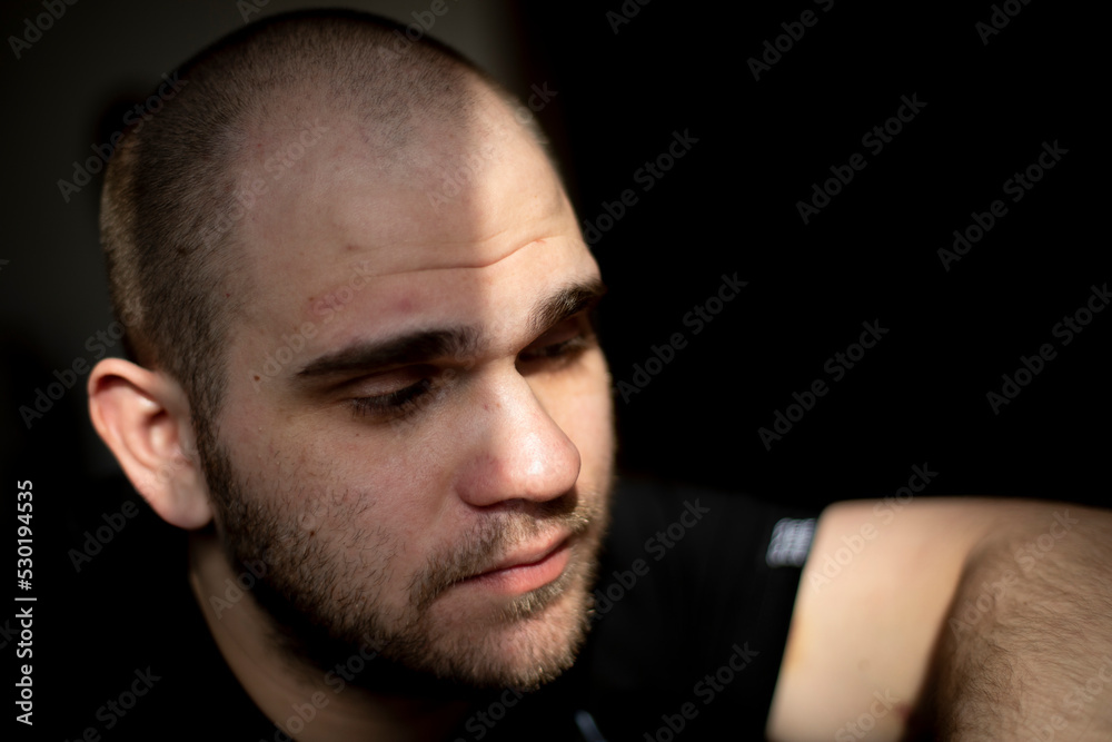 Fototapeta premium Guy's face is in light. Portrait of young man.