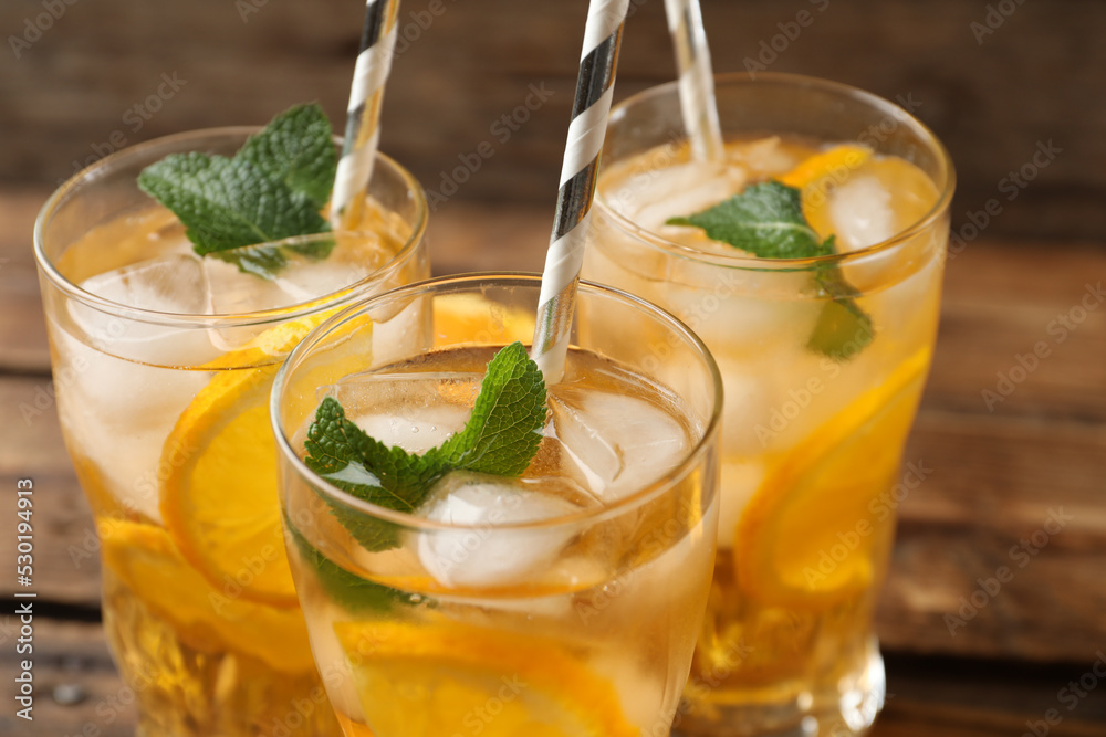 Fototapeta premium Delicious refreshing drink with orange slices on table, closeup