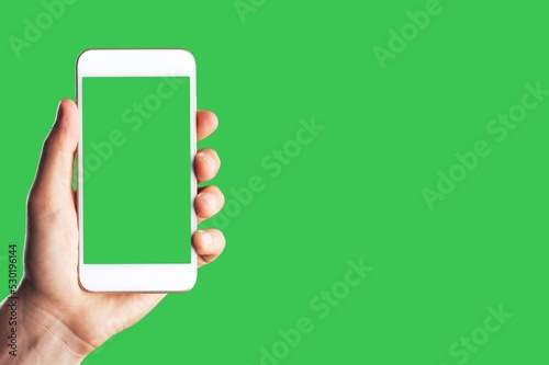 Blank smartphone screen on the green background