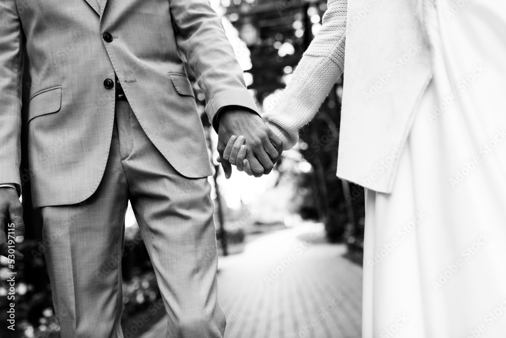 black and white photo of newlyweds hands