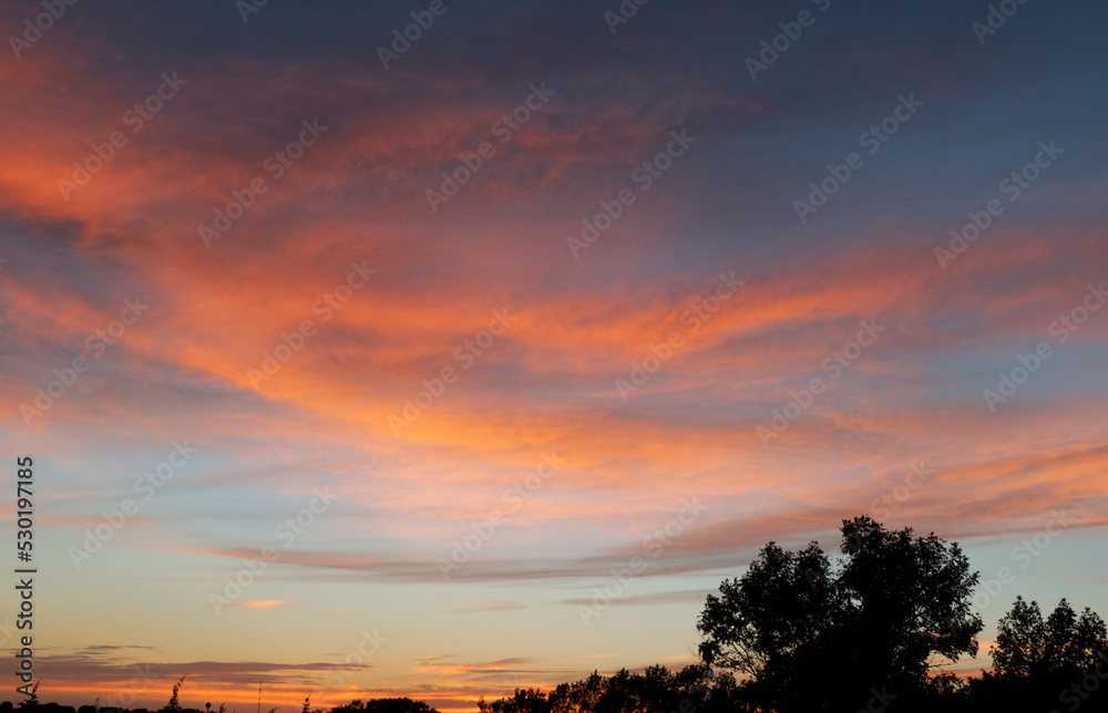 orange sunset with clouds above