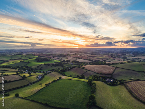 Sunset over Farmlands and Fields from a drone, Devon, England, Europe