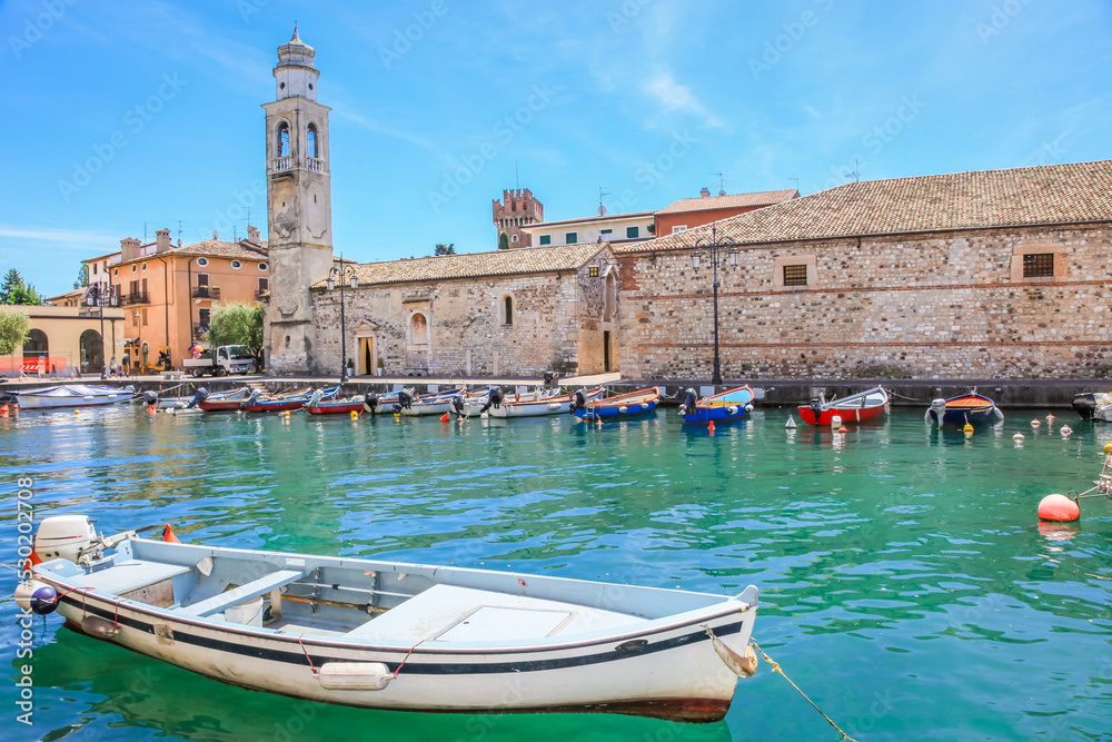 Idyllic lake Garda coastline in Lazise with boat, Northern Italy