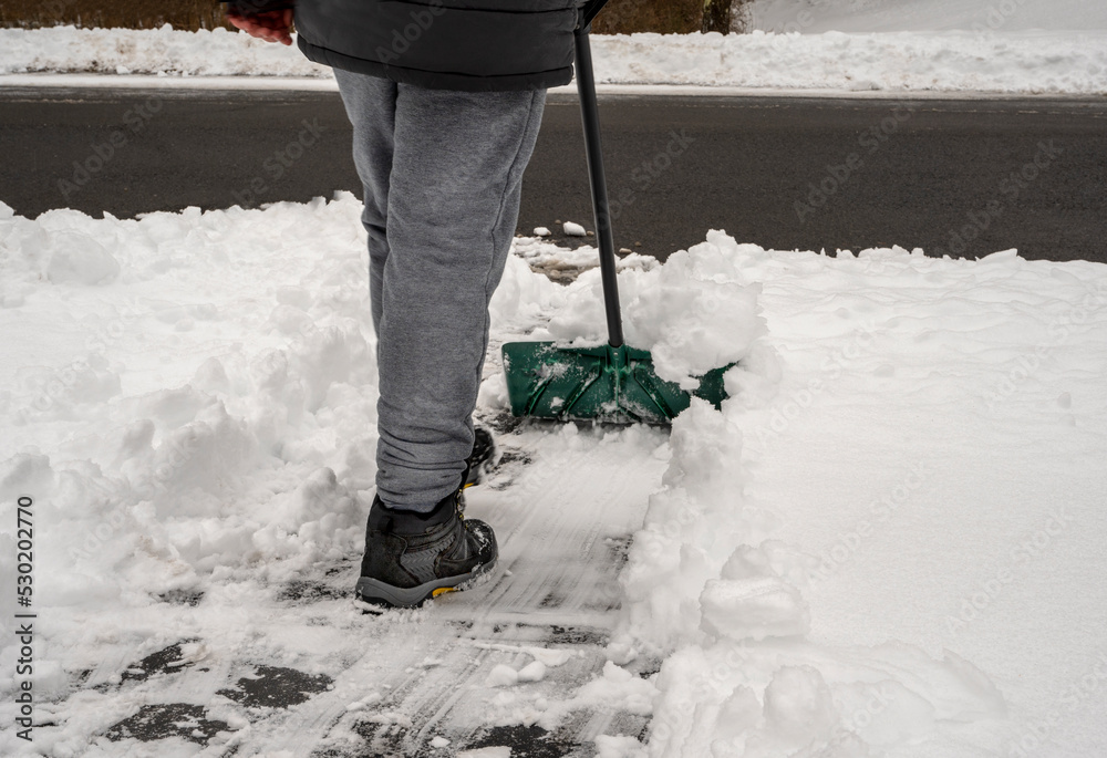 man shoveling snow from driveway. Winter and cleaning concept.
