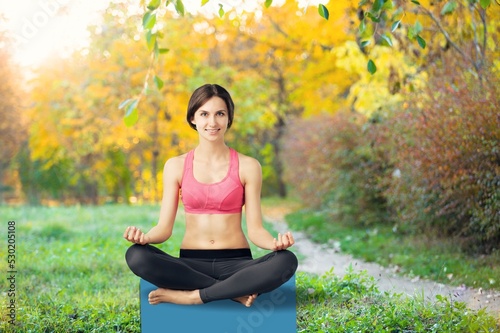 Beautiful woman doing yoga relaxed in the park