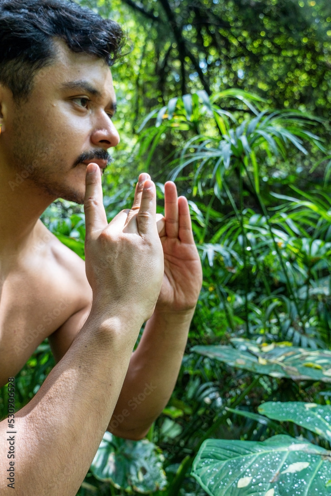 man seen up close, without shirt doing stretches on yoga mat, exercise, latin america man seen up close, without shirt doing stretches on yoga mat, exercise, latin america