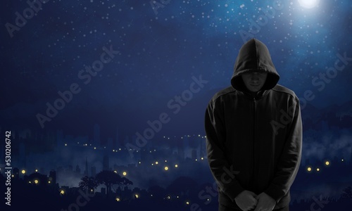 Silhouette of man in hoody on space and stars background