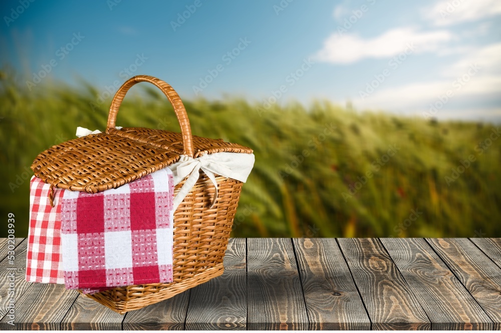 A picnic basket on desk with outdoor background. Shavuot holiday A picnic basket on desk with outdoor background. Shavuot holiday
