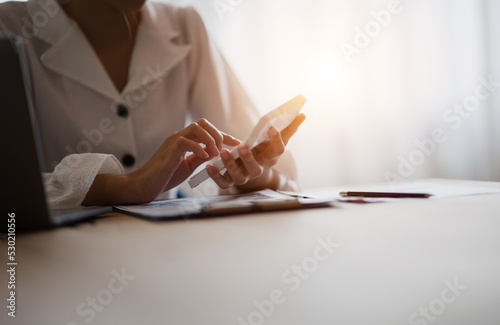 Close-up shot of a beautiful young businesswoman working on a calculator and laptop in the office. accountant work concept