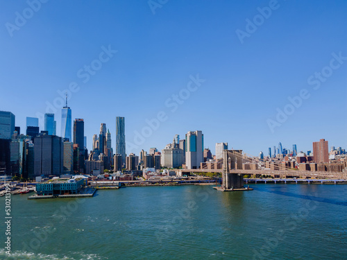On the Hudson river, a panoramic view of Brooklyn Bridge New York City of the midtown Manhattan skyline of cityscape America © ungvar