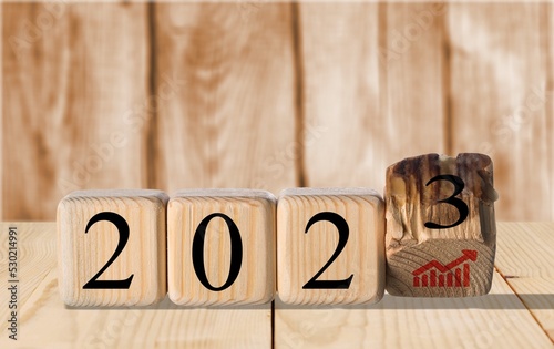 Concept of 2023. Wooden cubes inscripted growth icon photo