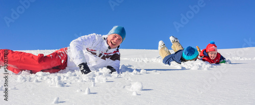 Familie hat Spass im Schnee an seinem sonnigen Wintertag 